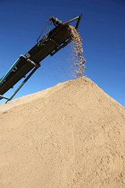 Sand pile and conveyor